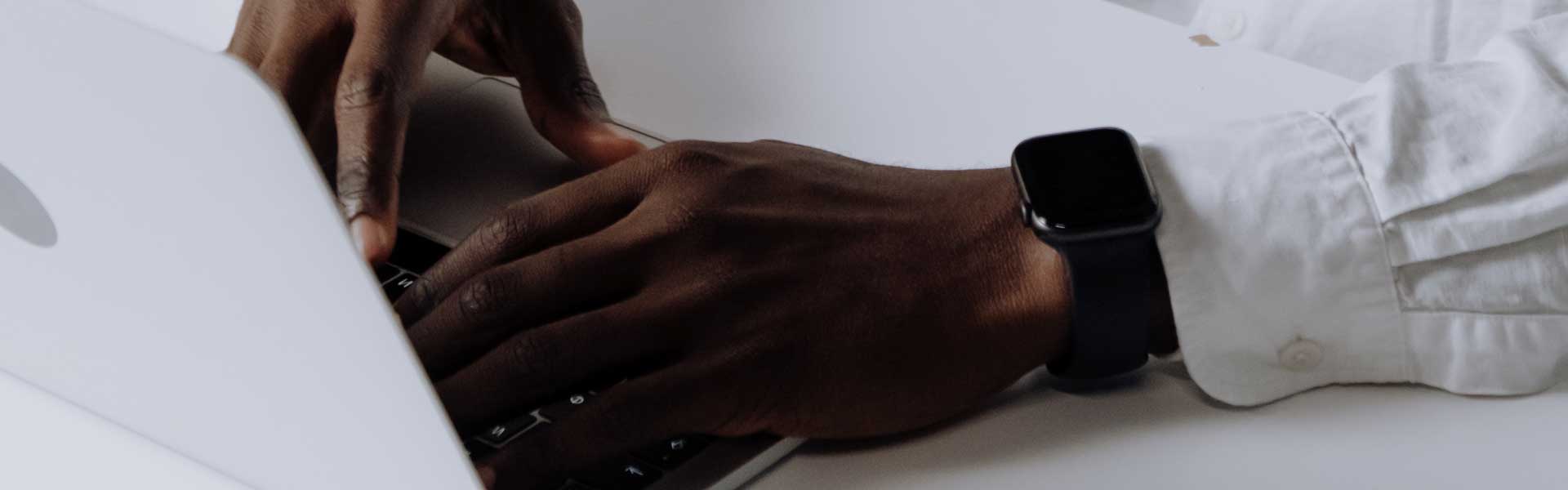 hands typing on a netbook