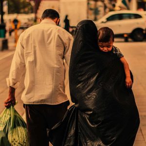 Man, woman and child walking down the road