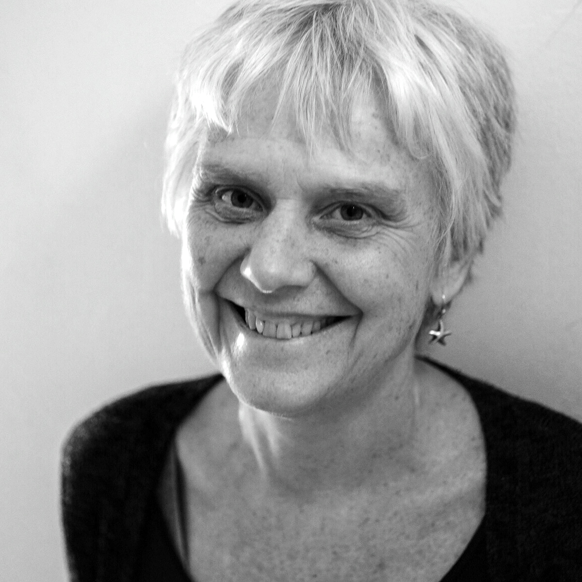 Headshot of Sara Burns looking up at the camera and smiling