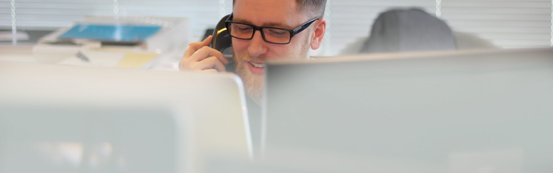 Stock photo of a man on the phone working remotely