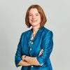 Headshot of Joy MacKeith standing against a plain white background