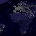 Stock photograph of a world map with lights at night