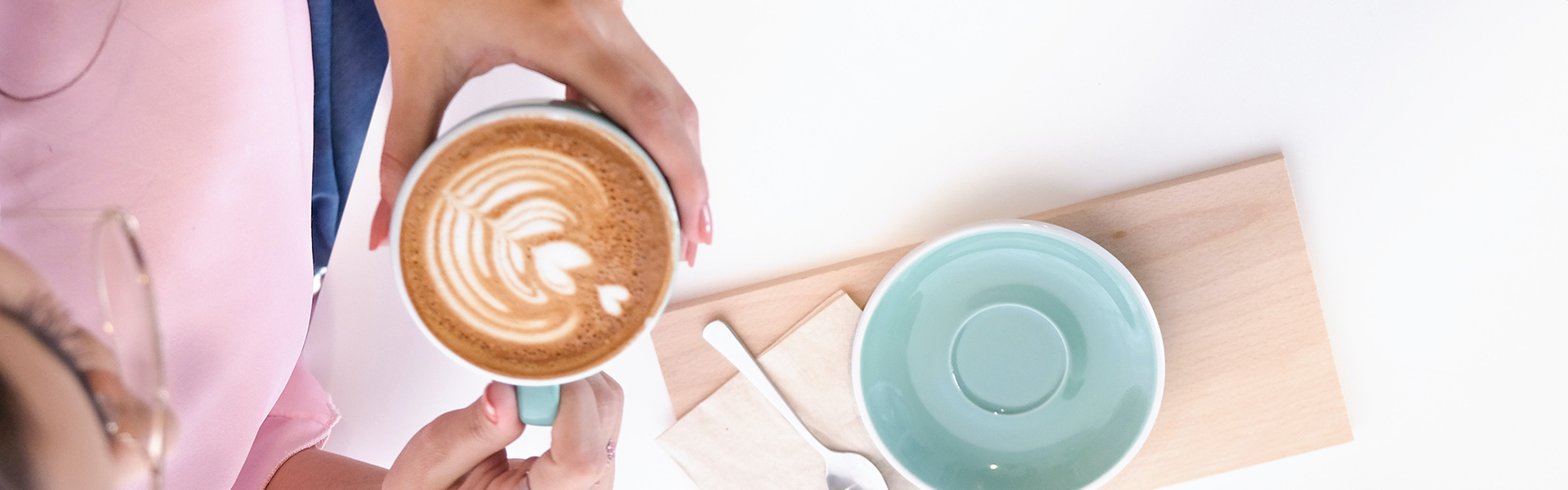 Stock photograph of a woman's hands holding a cup of coffee