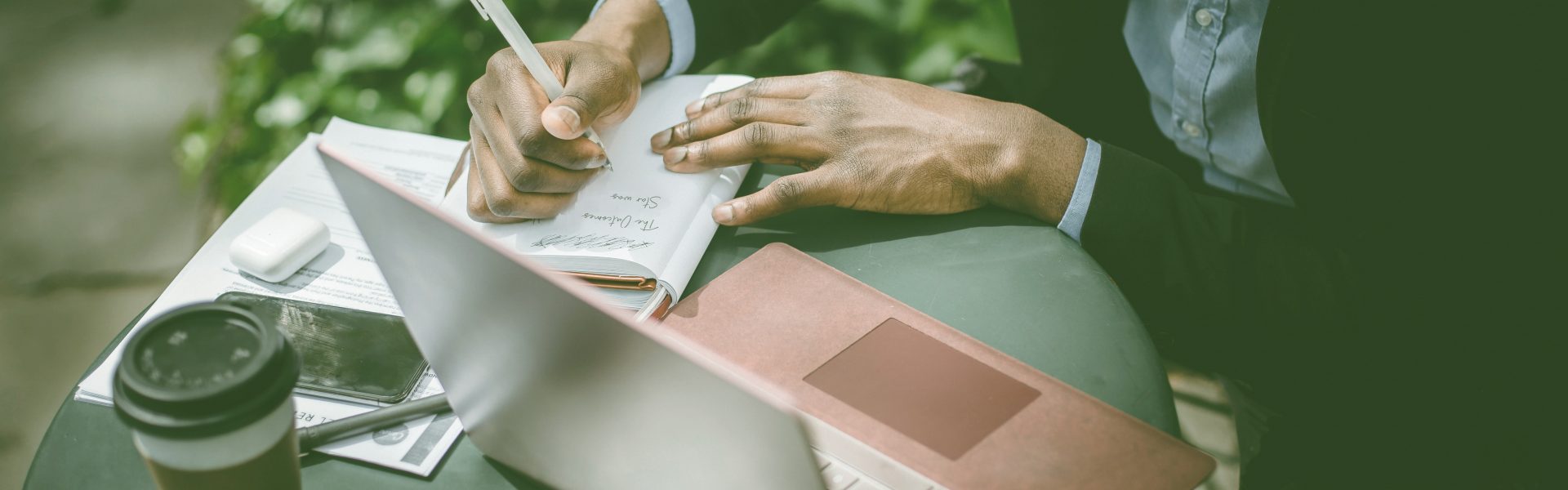 Photograph of a man writing and working